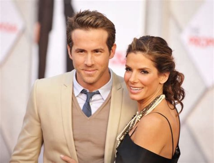 What is the age difference between Ryan Reynolds and Sandra Bullock?