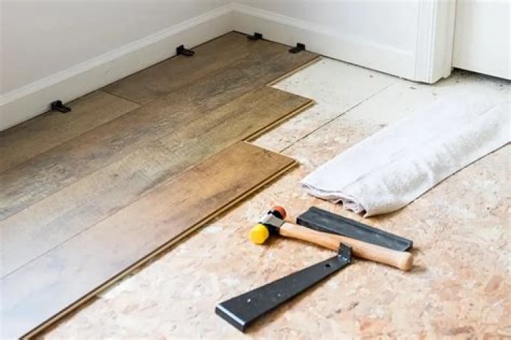 Where do you start vinyl plank flooring in a bedroom?